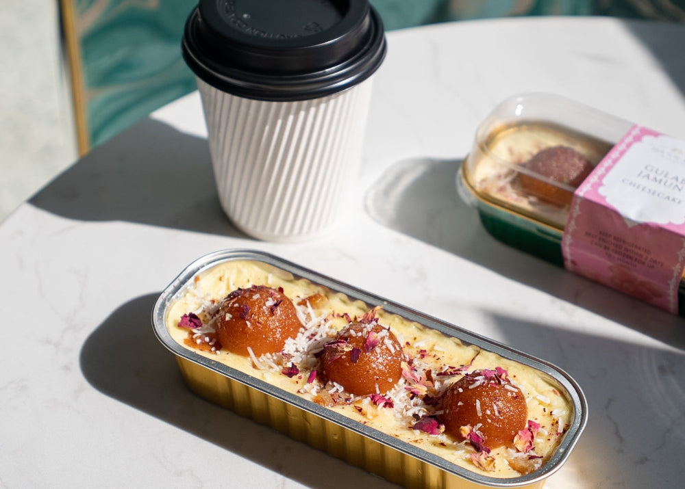 Dessert with a coffee cup on a table with a Mann & Co. branded napkin.